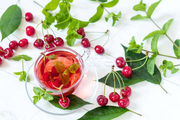 Fresh fruit cherry drink in transparent glass cup surrounded by  Stock photo © artsvitlyna