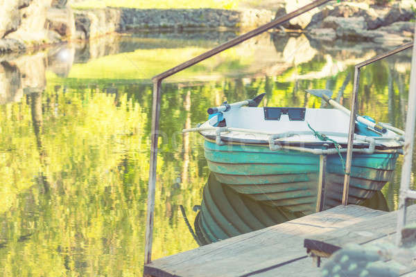 Blue wooden boat in the park pond on a sunny day Stock photo © artsvitlyna