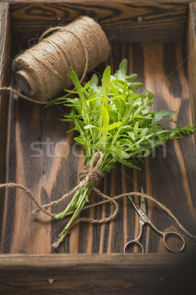  Fresh arugula bouquet in wooden box Stock photo © artsvitlyna