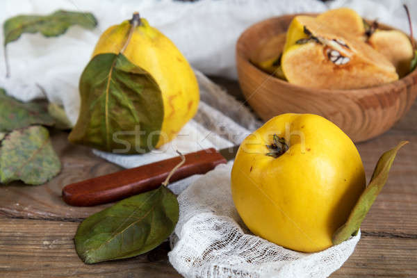 Fresh quince fruit on dark wooden table Stock photo © artsvitlyna