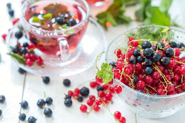 Fresh red and black currant in glass vase Stock photo © artsvitlyna