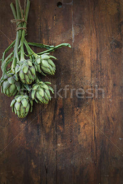 Artichoke bouquet in wooden background Stock photo © artsvitlyna