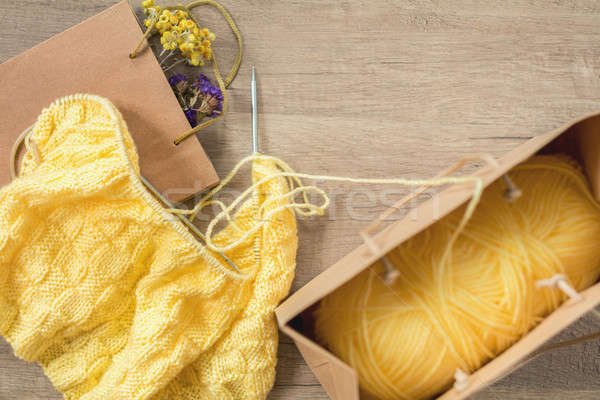 Light yellow knitting wool and knitting needles on wooden backgr Stock photo © artsvitlyna