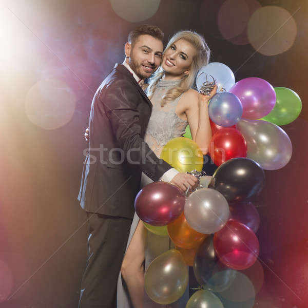 Smiling couple in love on the new years eve party Stock photo © arturkurjan