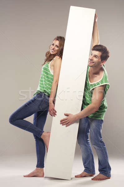 Portrait of a young couple who standing with blackboard Stock photo © arturkurjan