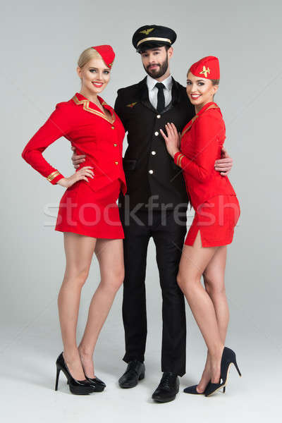 Happy group of pilots and stewardesses Stock photo © arturkurjan