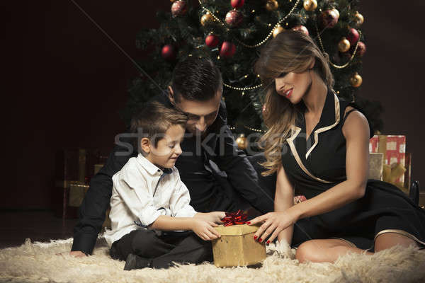 Happy family near Christmas tree Stock photo © arturkurjan