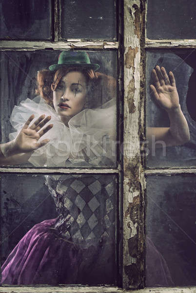 A lonely pierrot woman behind the glass Stock photo © arturkurjan