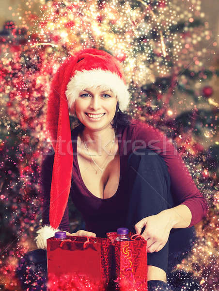 Stock photo: Beautiful middle age woman in santa hat in abstract backgroundCh