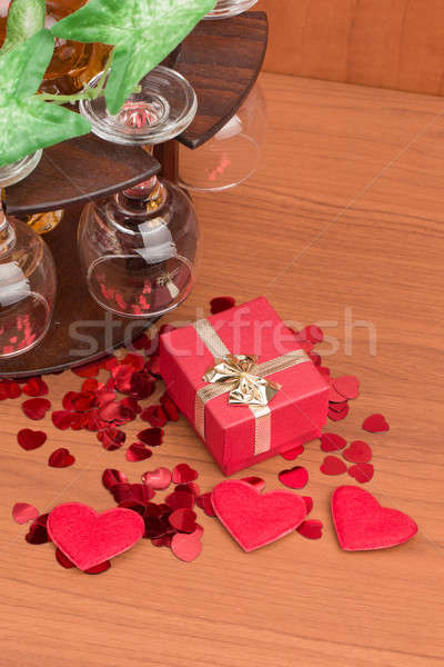 glass of vine, red hearts and small present Stock photo © artush