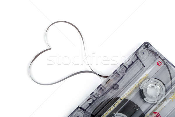 Audio cassette tape on white backgound. Film shaping heart Stock photo © artush