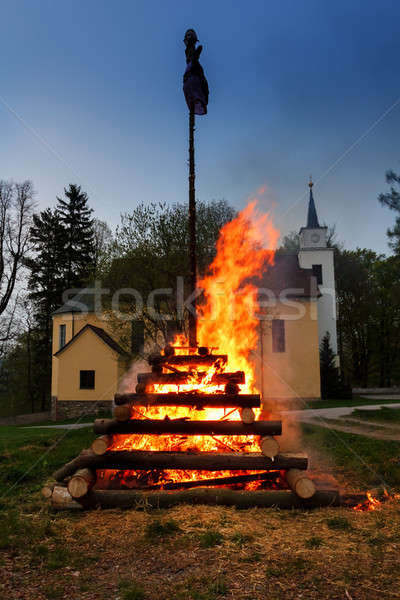 Stock photo: big walpurgis night fire with witch on pile behind the church