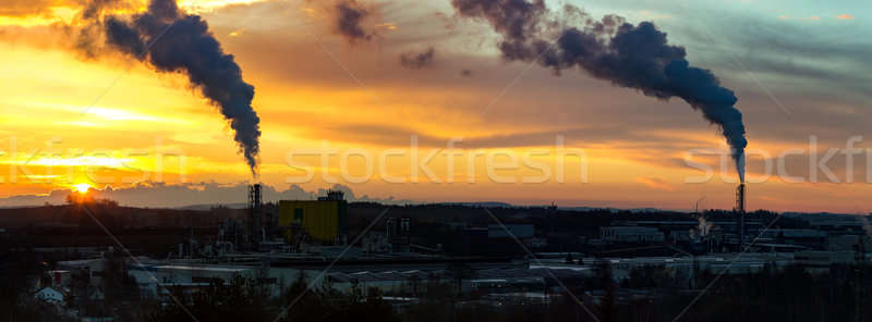 Sunrise silhouette of smoking factory Stock photo © artush
