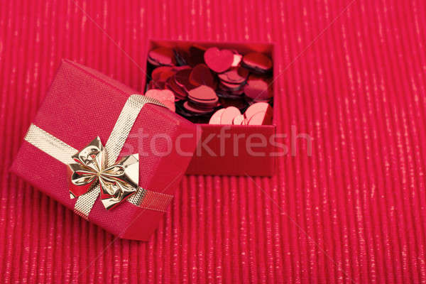 Red hearts confetti on fabric background Stock photo © artush