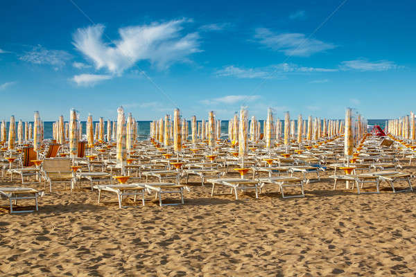 withdrawn umbrellas and sunlongers on the sandy beach Stock photo © artush