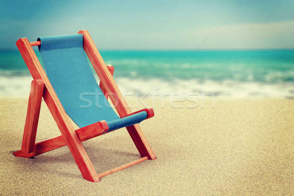 Sun lounger in sandy beach vintage toned Stock photo © artush