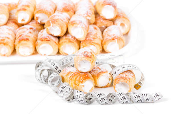concept of slimming, cakes with measuring tape Stock photo © artush