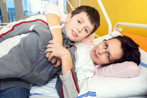 sad middle-aged woman lying in hospital with son Stock photo © artush