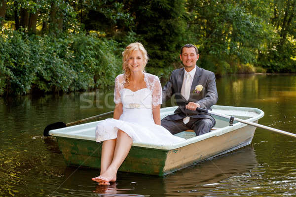 Young just married bride and groom on boat Stock photo © artush