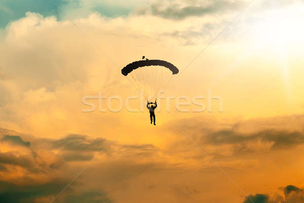 unidentified skydiver, parachutist on blue sky Stock photo © artush