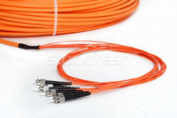 Stock photo: orange fiber optic ST connector patchcord