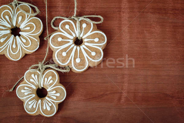 Gingerbread cookies hanging over wooden background  Stock photo © artush