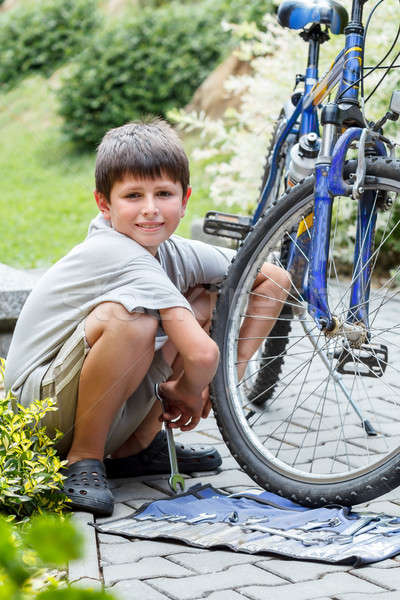 Teenager repairing his bike, changing broken tyre Stock photo © artush