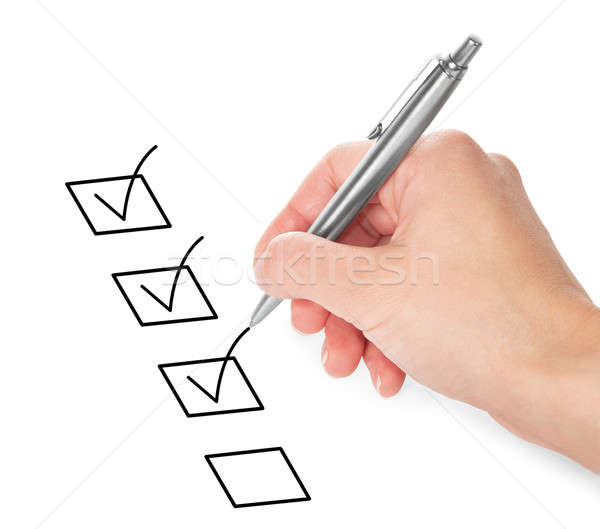 Stock photo: Hand with pen and check boxes