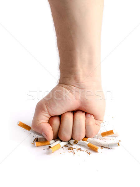 Man's fist crushing cigarettes Stock photo © ashumskiy