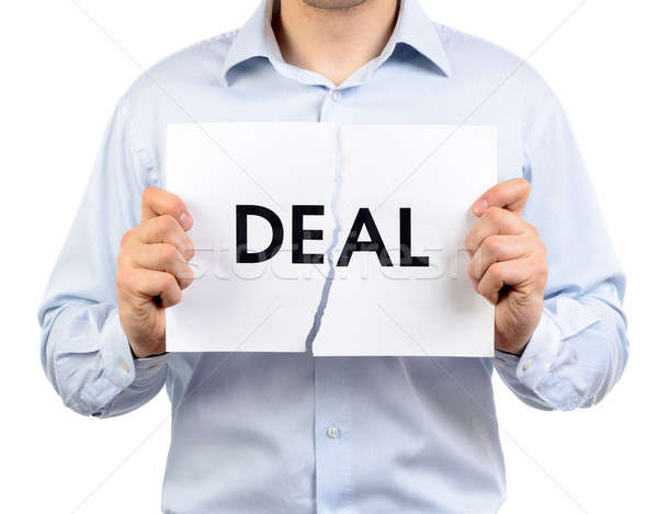Man holding a torn paper which says 'Deal' Stock photo © ashumskiy