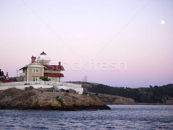 view of lighthouse and inn on a moonlit night Stock photo © aspenrock