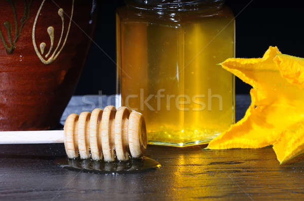 Jar of honey and wooden stick Stock photo © asturianu