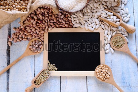 Different types of beans around black framed square on blue wood Stock photo © asturianu