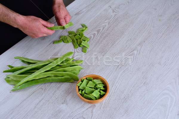 Felismerhetetlen férfi vág zöld zöldborsó közelkép Stock fotó © asturianu