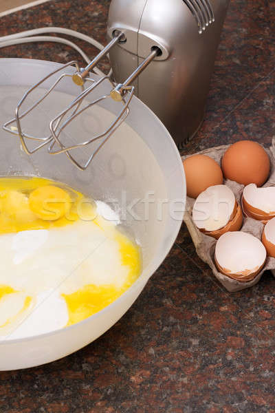 Stock photo: Cake ingredients in bowl and electric mixer