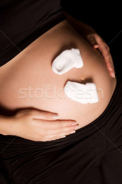 Mujer embarazada bebé calcetines vientre tocar mujer Foto stock © avdveen