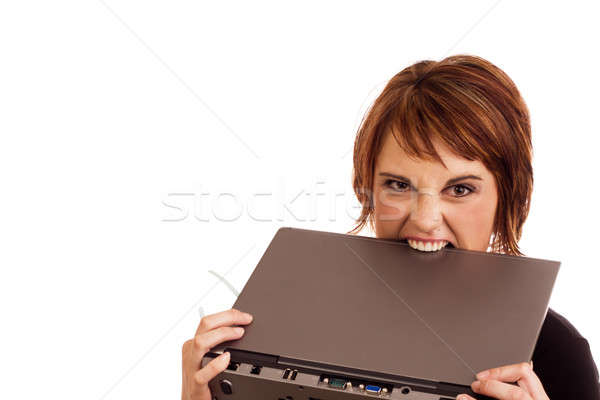 Frustrated Caucasian businesswoman biting laptop Stock photo © avdveen