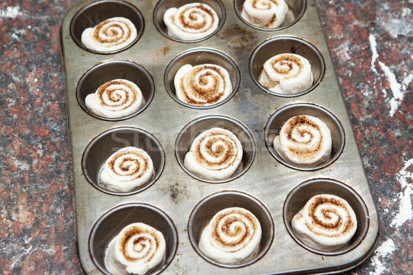 Mini cinnamon rolls ready to be baked Stock photo © avdveen