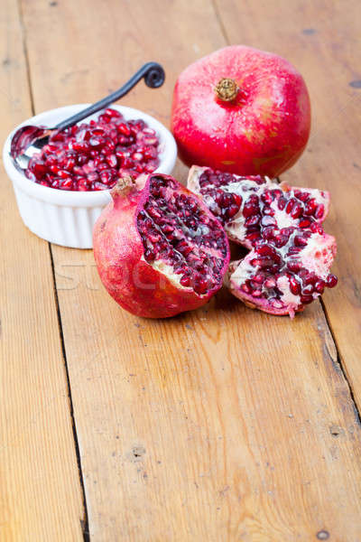 Fresh pomegranate fruit and pips in white bowl Stock photo © avdveen