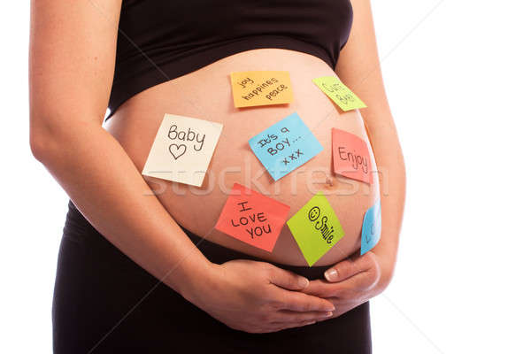Pregnant Caucasian woman with sticky notes on belly Stock photo © avdveen