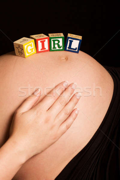 Caucasian pregnant woman with wooden blocks on tummy Stock photo © avdveen