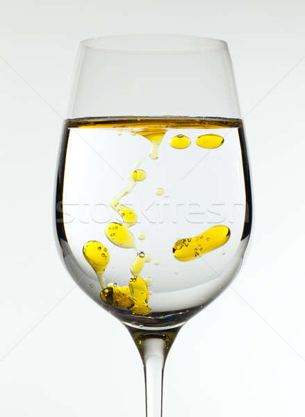 Olive oil being poured into wine glass Stock photo © backyardproductions
