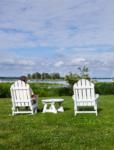 Single senior man in white chairs overlooking bay Stock photo © backyardproductions