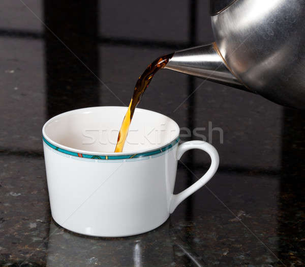 Tea poured from stainless steel teapot Stock photo © backyardproductions