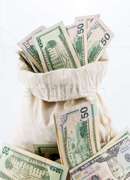 Many US dollar bills or notes with money bags Stock photo © backyardproductions