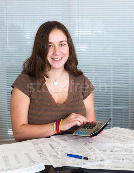Young lady preparing USA tax form 1040 for 2012 Stock photo © backyardproductions