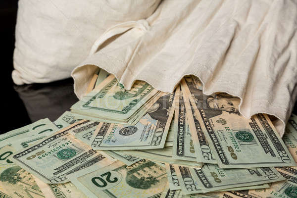 Many US dollar bills or notes with money bag Stock photo © backyardproductions