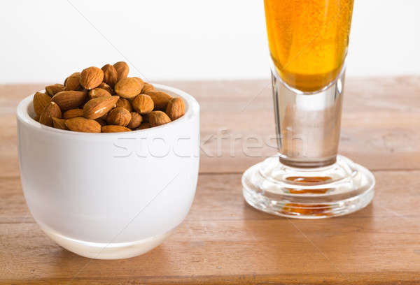 Bowl of raw almond nuts on wooden table Stock photo © backyardproductions