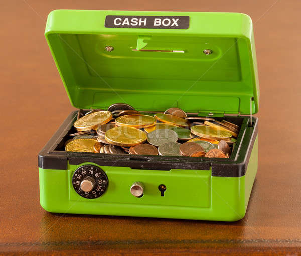 Green cash box with gold and silver coins Stock photo © backyardproductions