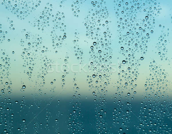 Raindrops on window of a ship at sea with horizon Stock photo © backyardproductions